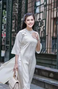VGU No.162: Modern Ao Dai Grace: Vietnamese Woman's Elegant Style & Allure on City Streets. - image 2