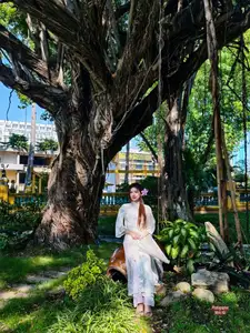 Graceful Ao Dai: Explore the Timeless Traditional Beauty of a Vietnamese Girl with an Elegant Parasol in a Lush Garden Setting - image 4