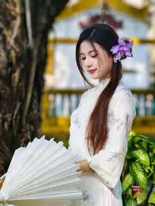 Graceful Ao Dai: Explore the Timeless Traditional Beauty of a Vietnamese Girl with an Elegant Parasol in a Lush Garden Setting - image 3