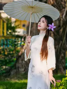 Graceful Ao Dai: Explore the Timeless Traditional Beauty of a Vietnamese Girl with an Elegant Parasol in a Lush Garden Setting - image 7