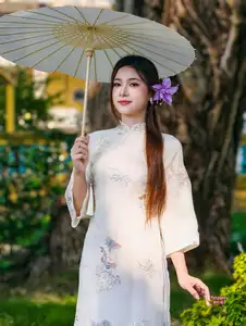 Graceful Ao Dai: Explore the Timeless Traditional Beauty of a Vietnamese Girl with an Elegant Parasol in a Lush Garden Setting - image 1