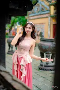 Graceful Woman in Pink Dress Amidst Ancient Heritage Charm 1000025280 - image 0