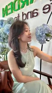 Asian Grace: Vietnamese Woman's Radiant Smile & Elegant Tea Moment - image 0