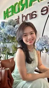 Asian Grace: Vietnamese Woman's Radiant Smile & Elegant Tea Moment - image 4