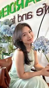 Asian Grace: Vietnamese Woman's Radiant Smile & Elegant Tea Moment - image 1