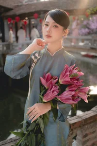 Classic Elegance: Vietnamese Tradition in Blue Silk and Pink Lilies - image 3