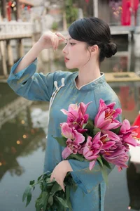Classic Elegance: Vietnamese Tradition in Blue Silk and Pink Lilies - image 1