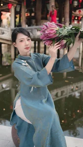 Classic Elegance: Vietnamese Tradition in Blue Silk and Pink Lilies - image 8