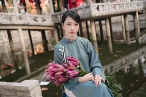 Classic Elegance: Vietnamese Tradition in Blue Silk and Pink Lilies - image 6