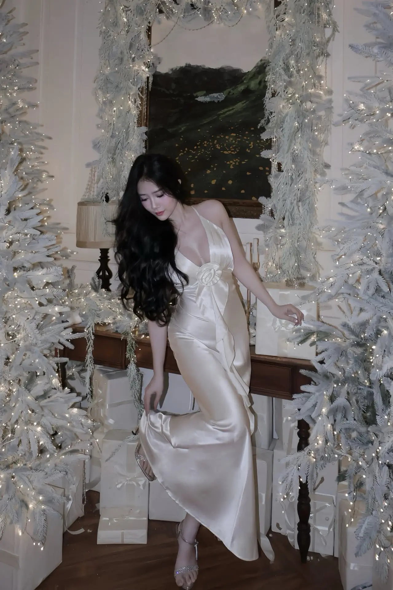 Christmas Muse: Elegant Beauty in a Backless Satin Dress by a Sparkling Tree