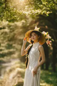Serene Vietnamese Beauty in White Ao Dai with Lilies: A Golden Hour Portrait 1000025192 - image 0