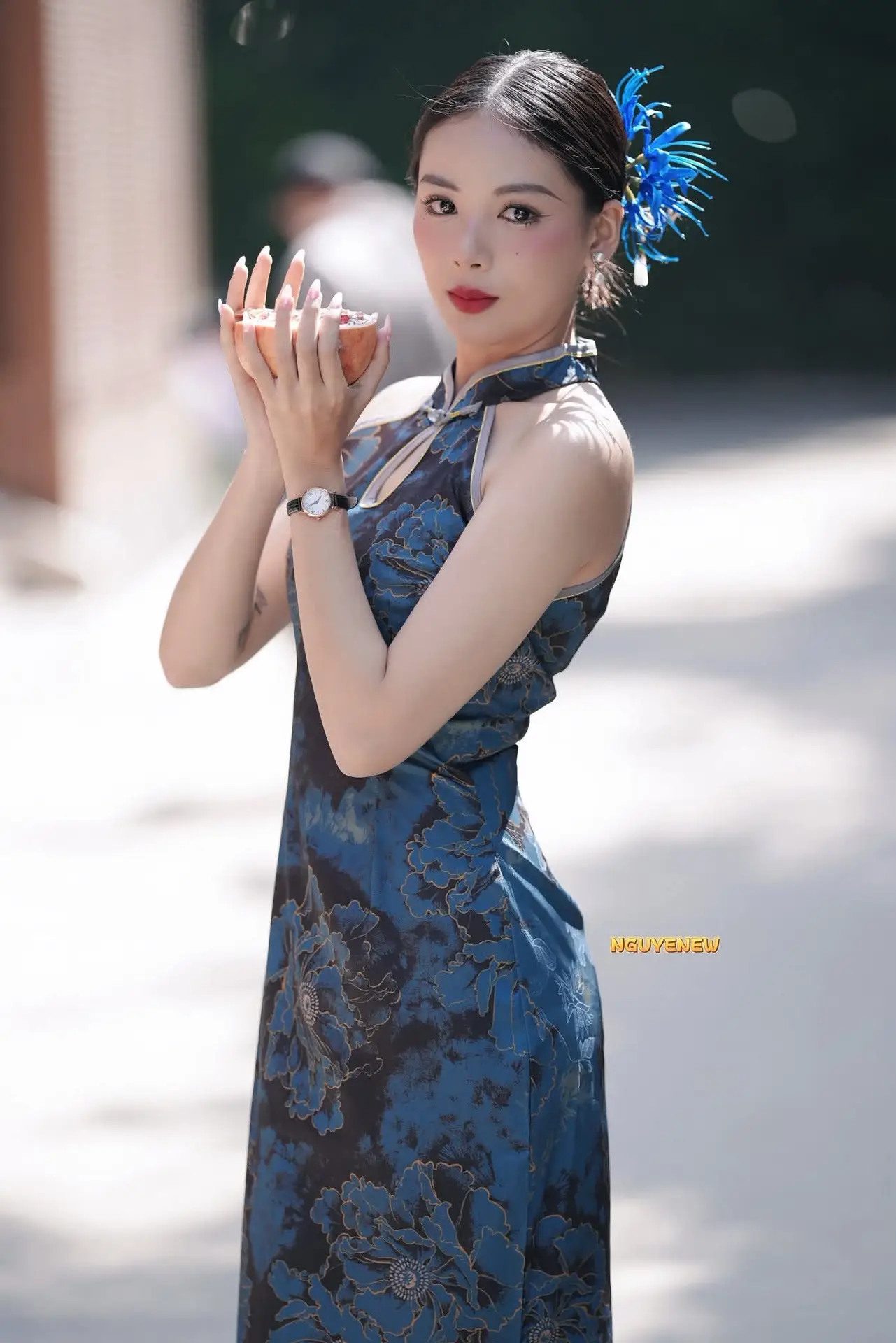 Captivating Asian Beauty: Elegant Woman in Blue Cheongsam with Traditional Fan