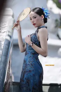 Captivating Asian Beauty: Elegant Woman in Blue Cheongsam with Traditional Fan - image 5