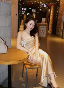 Elegant Young Woman in Golden Silk Dress Shines in Modern Urban Setting. Captivating Style. Code: 1000026984 - image 2