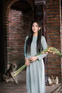Elegant Ao Dai Beauty: Vietnamese Girl's Grace with Flowers in a Classic Setting - image 3