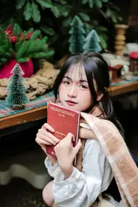 Cozy Christmas Reading: Young Woman and 'How to Win Friends' Book - image 1