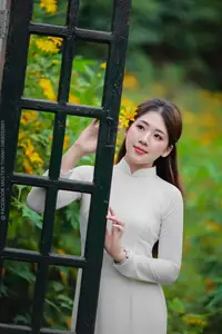 Radiant Youth: Vietnamese Girl in Elegant White Ao Dai Amidst Golden Blooms - image 23