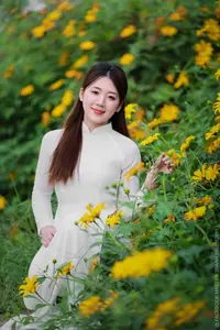 Radiant Youth: Vietnamese Girl in Elegant White Ao Dai Amidst Golden Blooms - image 16
