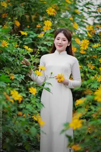 Radiant Youth: Vietnamese Girl in Elegant White Ao Dai Amidst Golden Blooms - image 15