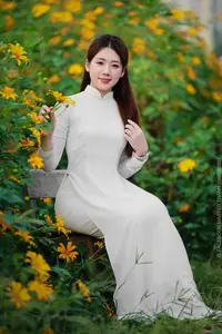 Radiant Youth: Vietnamese Girl in Elegant White Ao Dai Amidst Golden Blooms - image 12