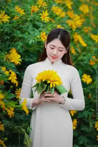 Radiant Youth: Vietnamese Girl in Elegant White Ao Dai Amidst Golden Blooms - image 4