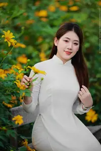 Radiant Youth: Vietnamese Girl in Elegant White Ao Dai Amidst Golden Blooms - image 9