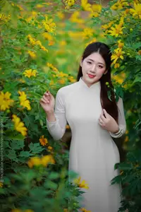Radiant Youth: Vietnamese Girl in Elegant White Ao Dai Amidst Golden Blooms - image 8
