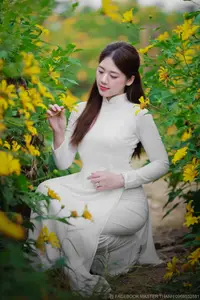 Radiant Youth: Vietnamese Girl in Elegant White Ao Dai Amidst Golden Blooms - image 5