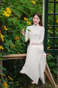 Radiant Youth: Vietnamese Girl in Elegant White Ao Dai Amidst Golden Blooms - image 19
