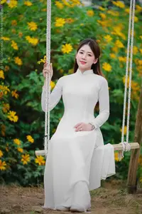 Radiant Youth: Vietnamese Girl in Elegant White Ao Dai Amidst Golden Blooms - image 14