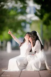 Graceful Vietnamese Girl in Elegant White Ao Dai with Sweet Finger Heart Gesture - image 9