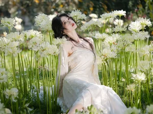 Ethereal Beauty in a White Flower Field: A Muse Under the Sun - image 11