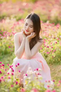 Serene Beauty: Young Woman in Pink Dress Amidst a Vibrant Flower Field - image 4