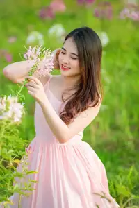Serene Beauty: Young Woman in Pink Dress Amidst a Vibrant Flower Field - image 2