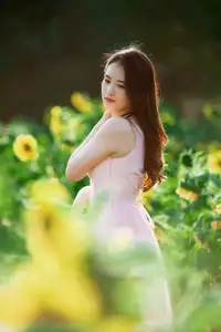 Serene Beauty: Young Woman in Pink Dress Amidst a Vibrant Flower Field - image 6