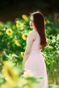 Serene Beauty: Young Woman in Pink Dress Amidst a Vibrant Flower Field - image 3