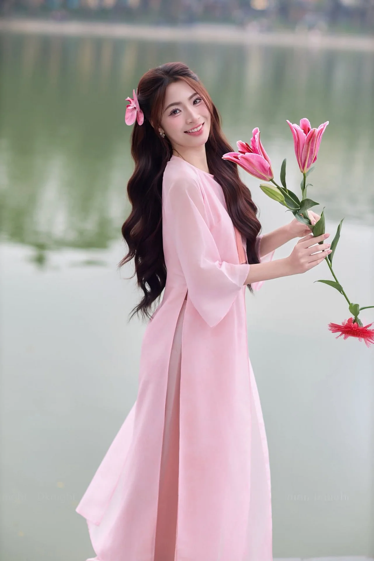 Gentle Pink Ao Dai: Vietnamese Beauty Shines by Hoan Kiem Lake in Spring Hanoi