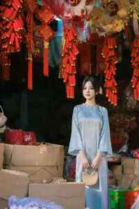 Traditional Vietnamese Beauty: Graceful Girl in Blue Ao Dai with Fresh Flowers - image 9
