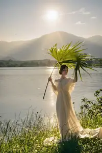 Golden Hour Serenity: Woman in White Dress Embracing Nature's Beauty by the Lake at Sunset. - image 8