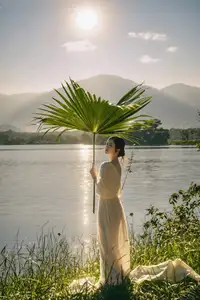 Golden Hour Serenity: Woman in White Dress Embracing Nature's Beauty by the Lake at Sunset. - image 9