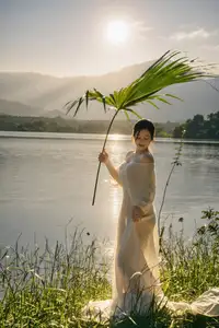 Golden Hour Serenity: Woman in White Dress Embracing Nature's Beauty by the Lake at Sunset. - image 6