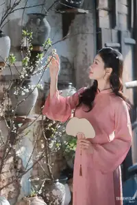 Serene Beauty of a Lady in Pink Traditional Dress with Spring Blossoms - image 12