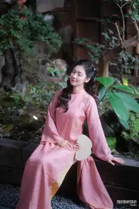 Serene Beauty of a Lady in Pink Traditional Dress with Spring Blossoms - image 3