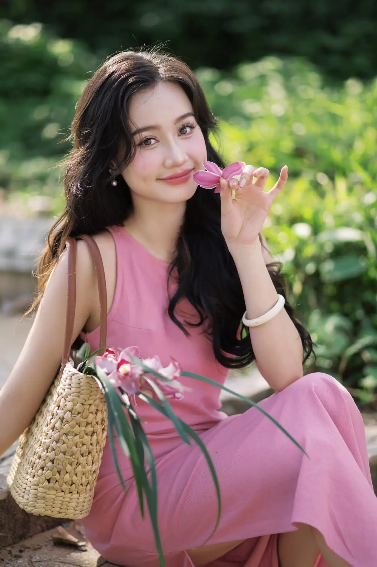 Captivating Grace: Long-Haired Beauty in Soft Pink Evokes Dreamy Serenity.