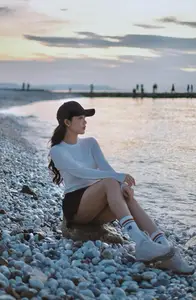 Dreamy Sunset by the Sea: Young Woman Relaxing and Gazing - image 5