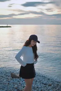 Dreamy Sunset by the Sea: Young Woman Relaxing and Gazing - image 3