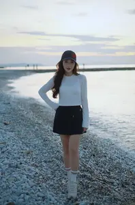 Dreamy Sunset by the Sea: Young Woman Relaxing and Gazing - image 2