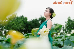 Graceful Beauty Queen in Traditional Yem Dress Amidst Early Season Lotus Blooms - image 5