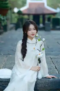 Pure Charm: White-Dressed Girl Winking Playfully with White Flowers 1000024585 - image 1