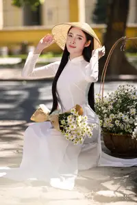 Vietnamese Ao Dai Beauty: Graceful girl with white daisies, an enchanting blend of tradition and charm. - image 6